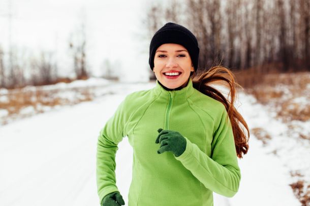 53950109 - happy young woman running in winter